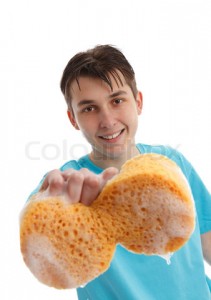 Boy using a soapy sponge to clean