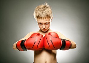 beautiful angry young boy play boxe with gloves